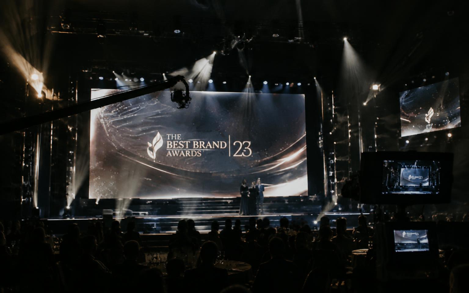 Placeholder: an awards stage with lighting, screens and broadcast cameras
