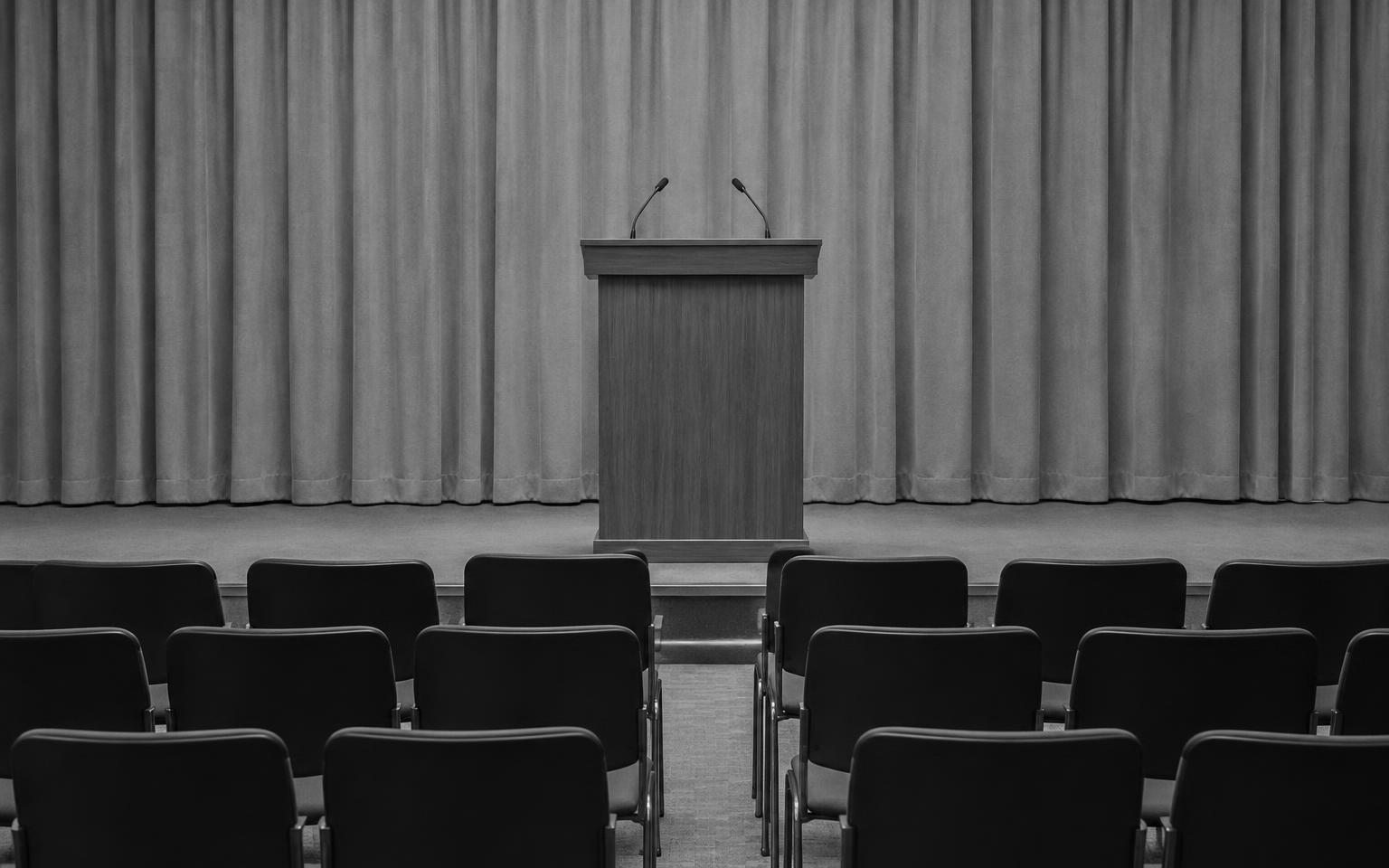 Placeholder: an empty government media briefing room with a podium
